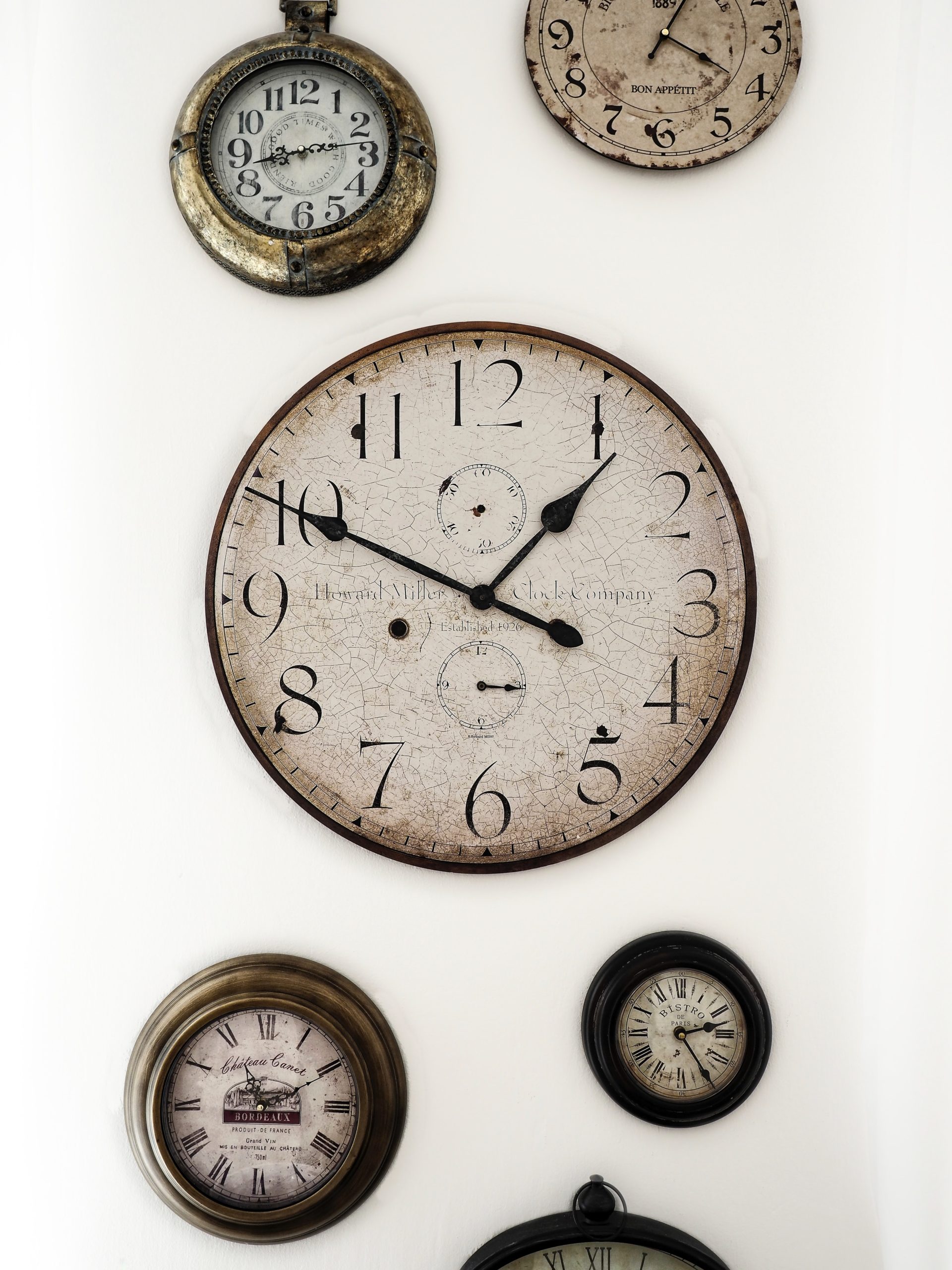 If you want to be successful while building a business, you need to learn the key to time management, which is why this photo shows many clocks perched on a wall.
